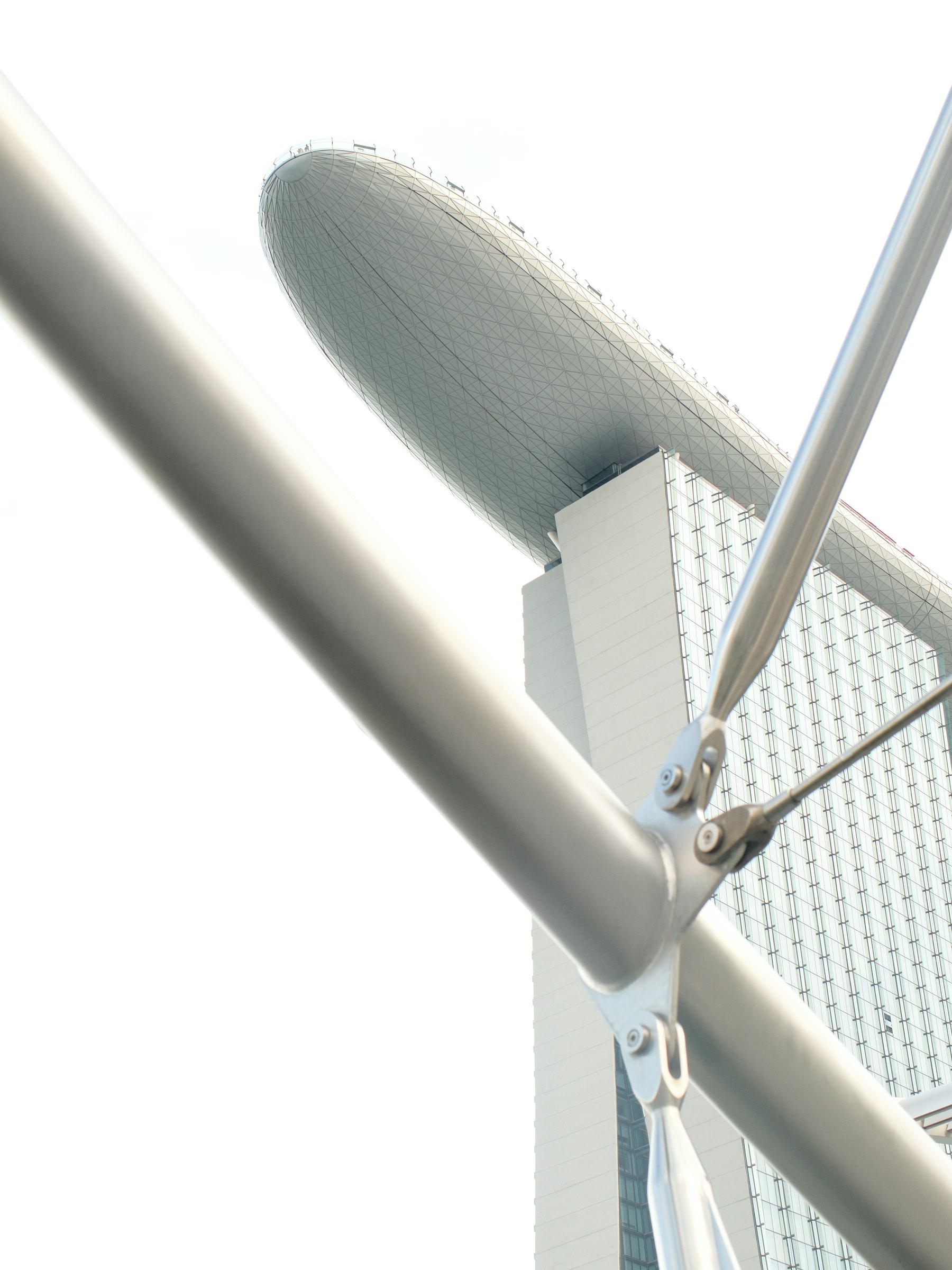 White steel and glass architecture against a bright Singapore sky